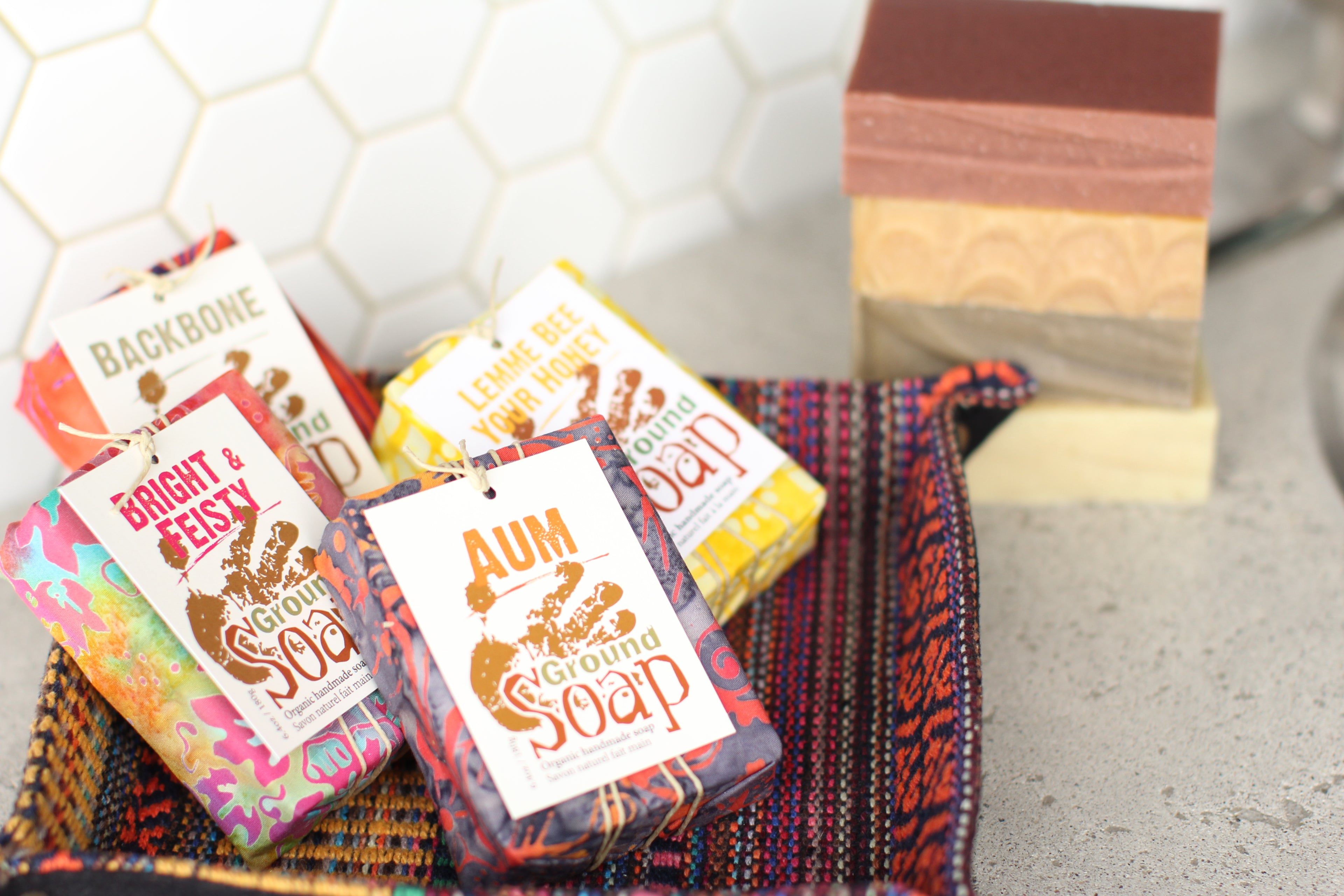 Four bars of Ground Soap: Aum, Bright & Feisty, Lemme Bee Your Honey, and Backbone