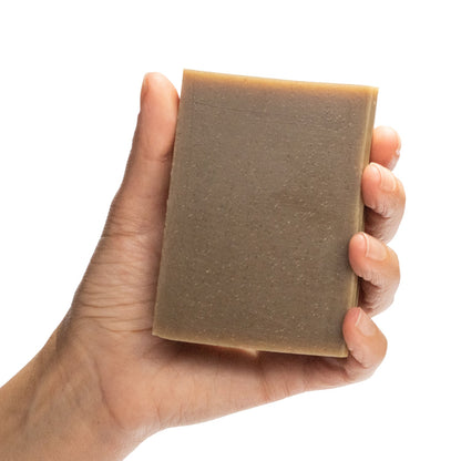 Aum Patchouli essential oil organic bar soap from Ground Soap being held in a hand. 