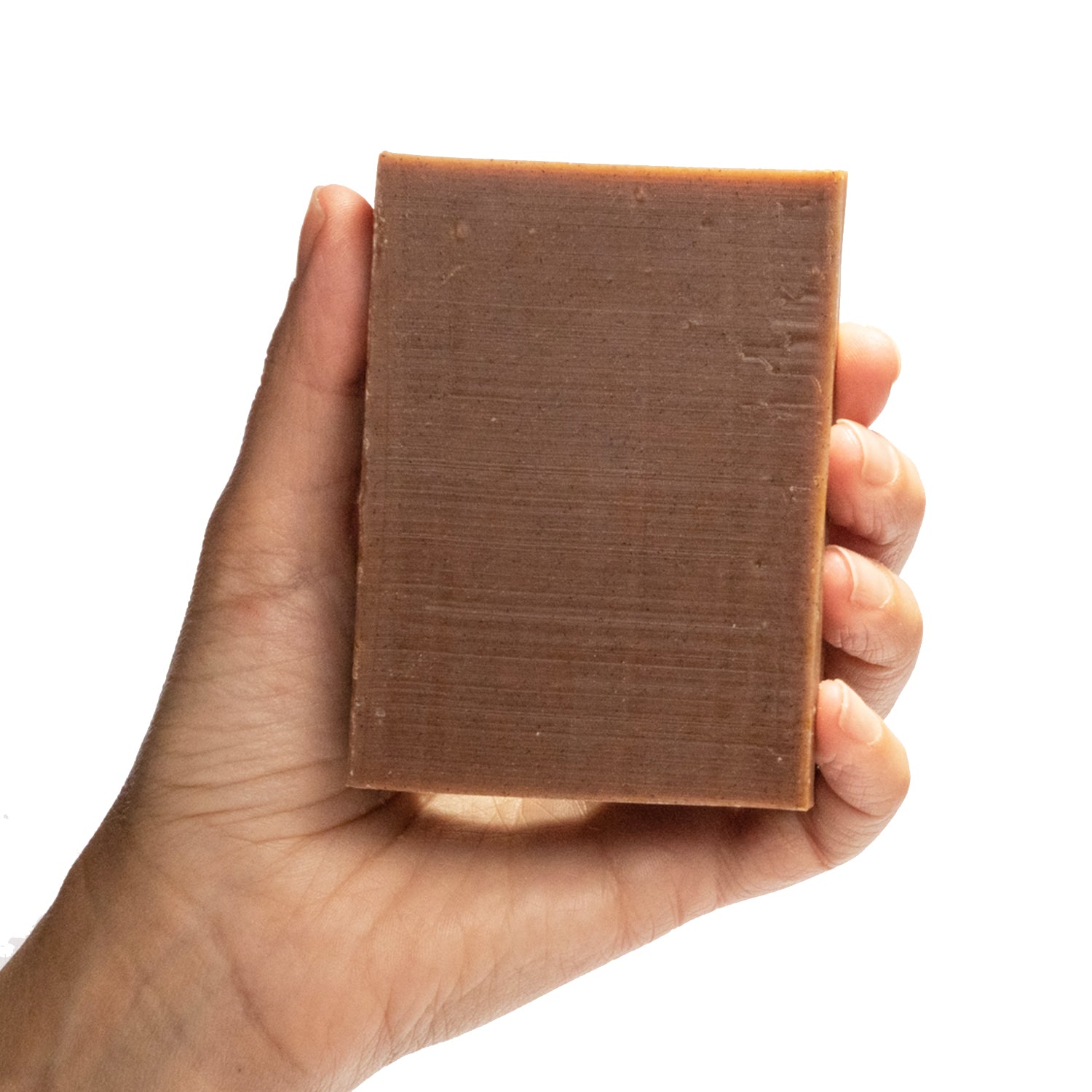 Three pack of naked Backbone cinnamon essential oil organic bar soap from ground Soap.  in hand.