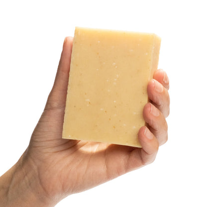 Naked Bright & Feisty citrus essential oil blend organic bar soap from ground Soap in hand.