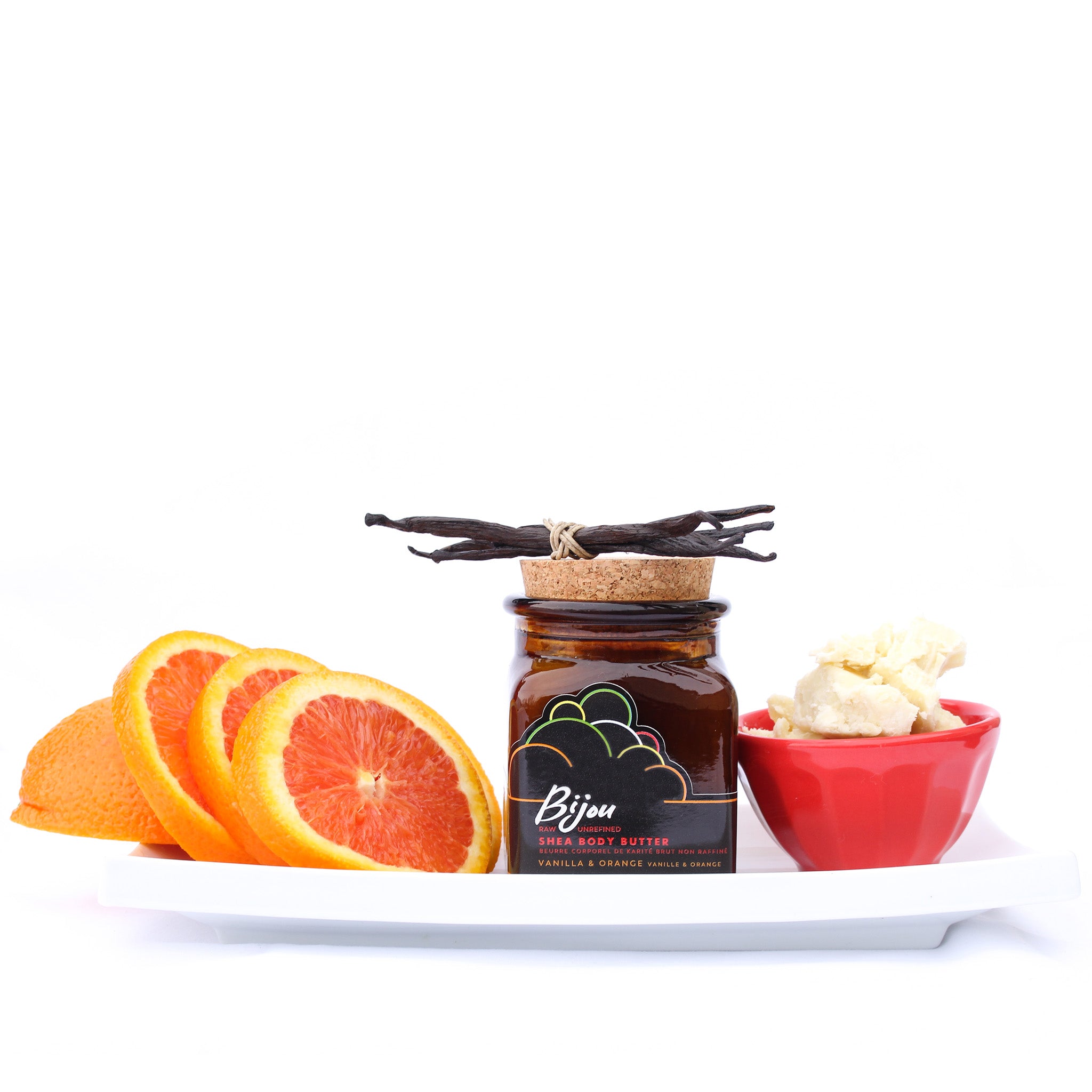 Bijou vanilla & orange shea body butter on a plate with slices of orange vanilla beans and shea butter