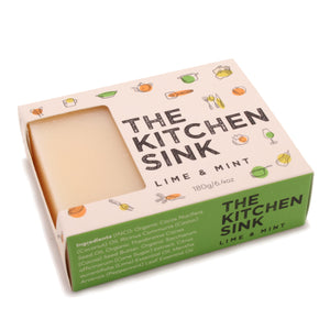A bar of the Kitchen Sink soap bar for the kitchen in the box lying down.