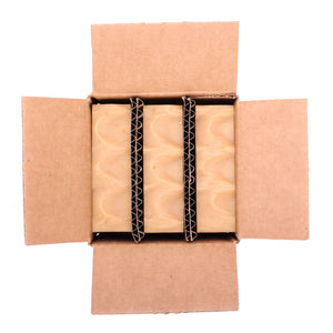 A naked three pack of Lemme Bee Your Honey lemon essential oil and honey organic bar soap from Ground Soap in a box.